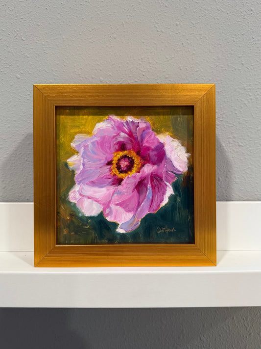 Framed painting of a pink flower on a gray wall
