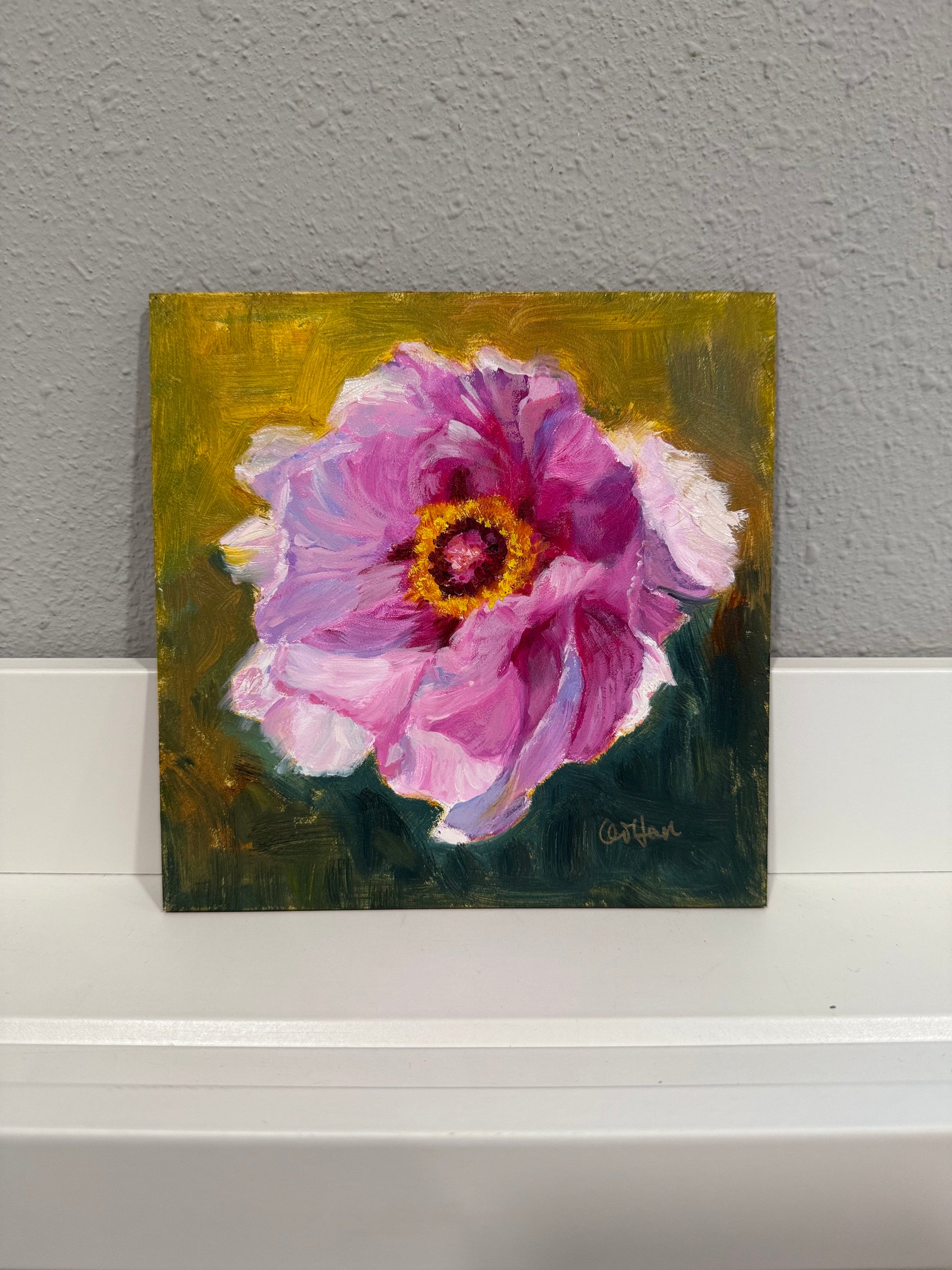 Painting of a pink flower on a gray wall