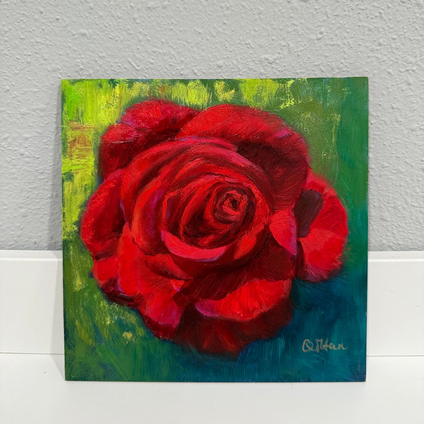 Painting of a red rose on a textured wall background